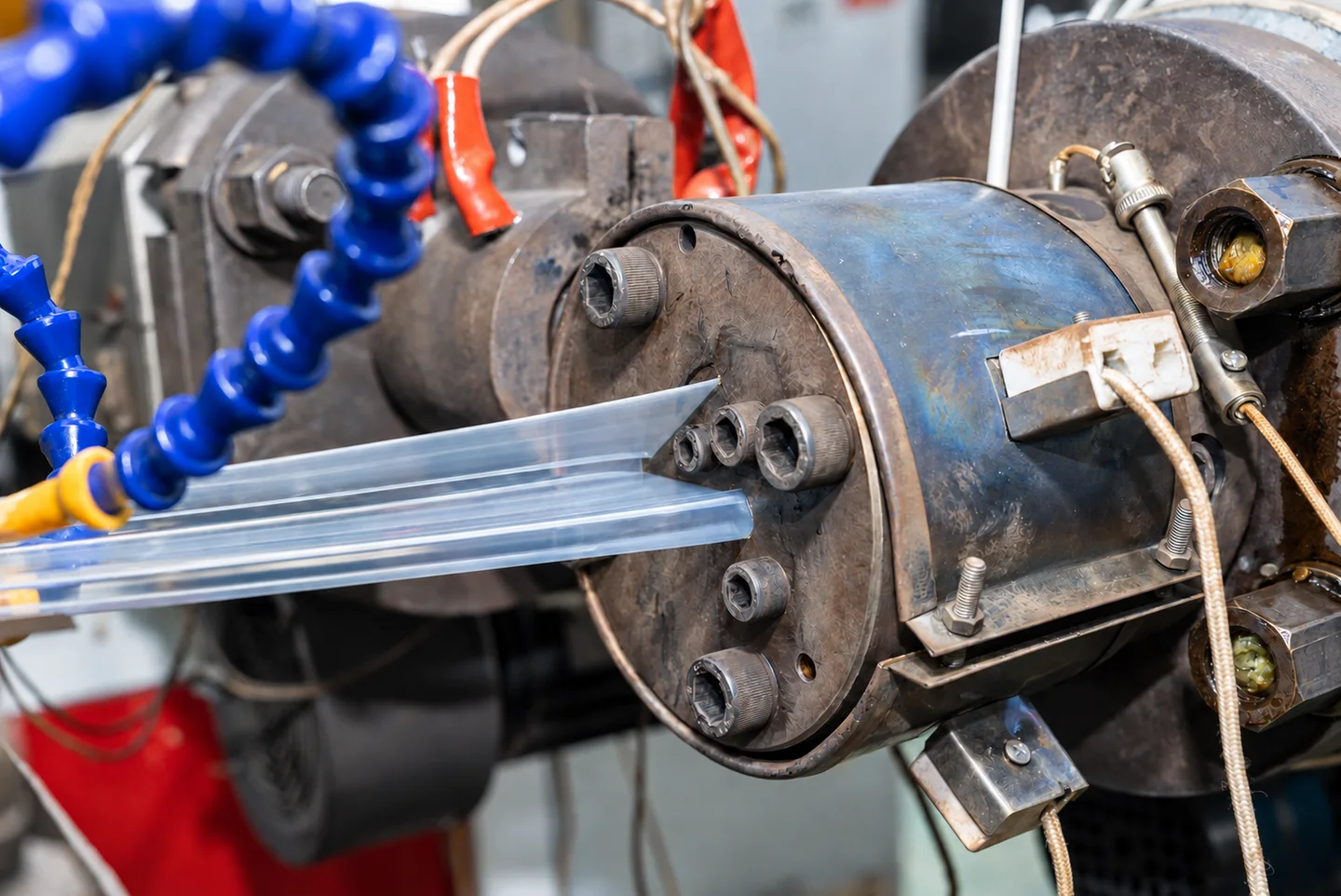 Extrusion process view showing a die and a transparent profile